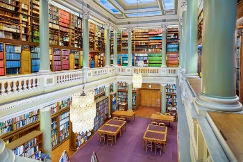 view over library with bookshelves and tall pillars